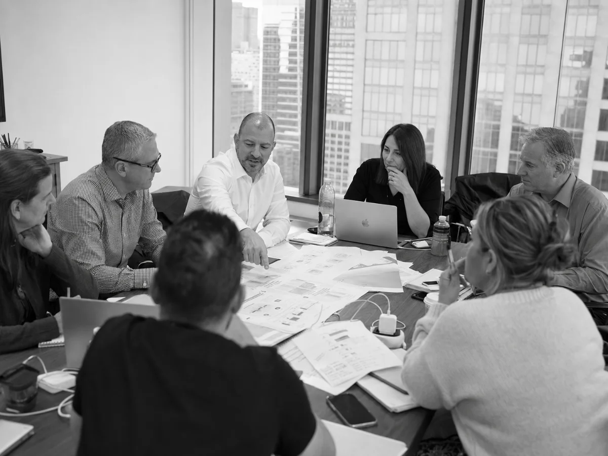 Colleagues reviewing strategy on a whiteboard